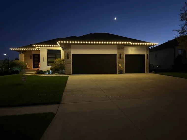 Christmas light installation following the full roofline of a ranch home at night in the Hillcrest area of Lincoln, NE